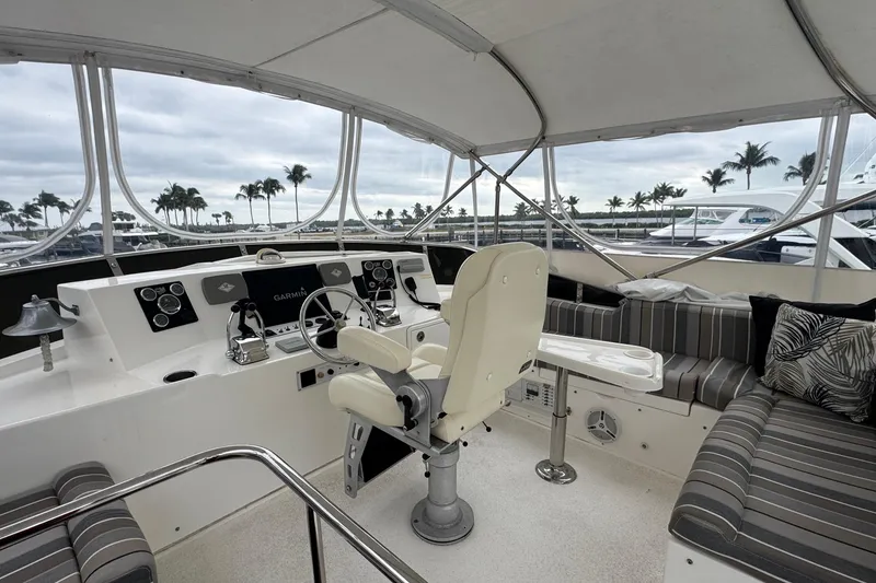 Slide: The Image of Luxurious 2007 Jefferson Pilothouse 52 SE yacht interior with helm and seating area. - 16