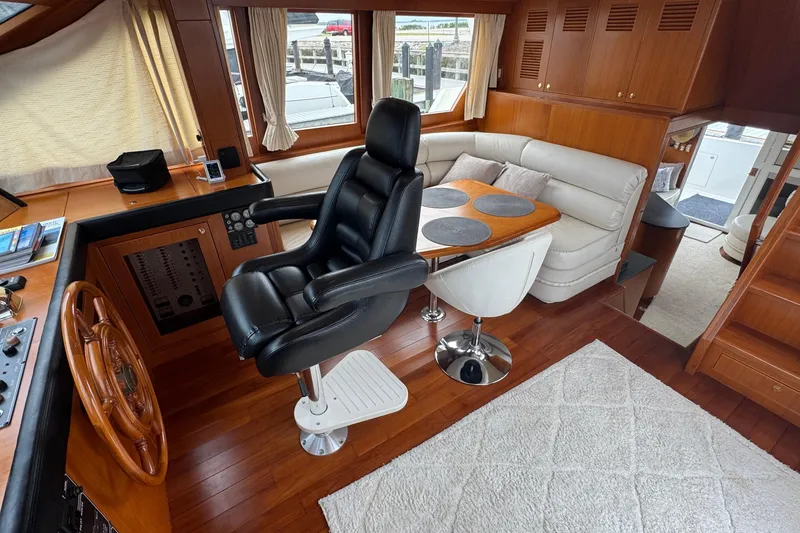 Slide: The Image of Luxurious interior of 2007 Jefferson Pilothouse 52 SE yacht with helm and seating area. - 24