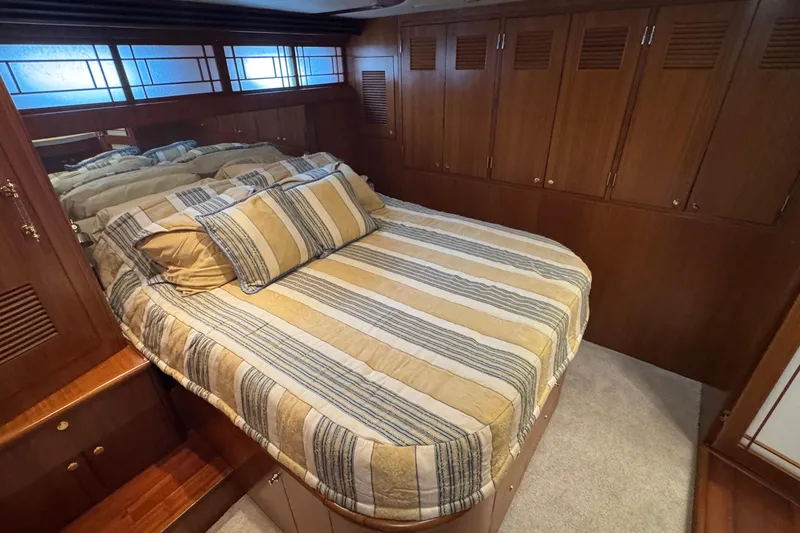 Slide: The Image of Luxurious bedroom interior of 2007 Jefferson Pilothouse 52 SE yacht with striped bedding. - 25