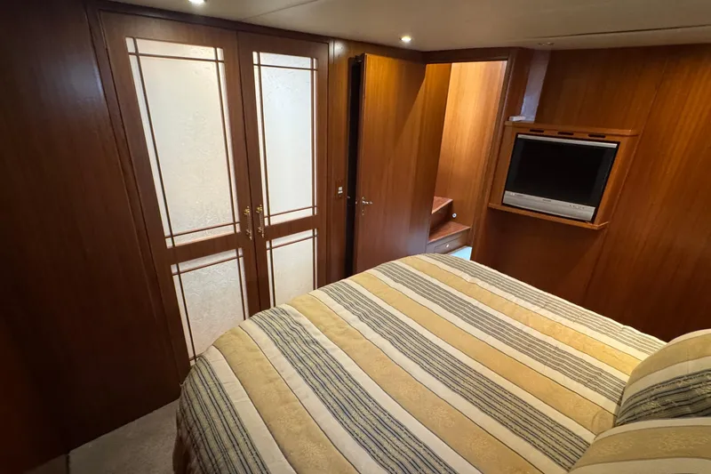 Slide: The Image of Luxurious cabin interior of 2007 Jefferson Pilothouse 52 SE yacht with wood paneling and TV. - 27