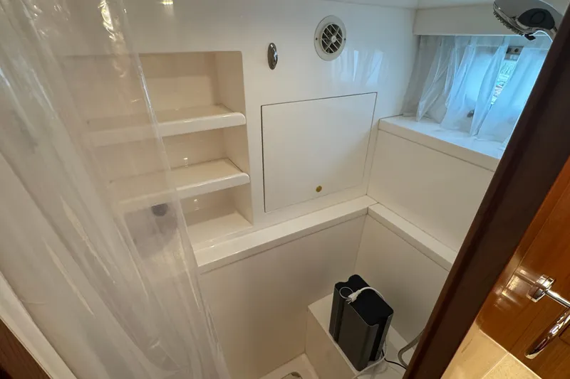 Slide: The Image of Compact bathroom with shelves and window in 2007 Jefferson Pilothouse 52 SE yacht. - 28