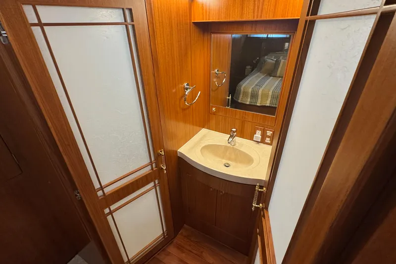 Slide: The Image of Luxurious bathroom interior of 2007 Jefferson Pilothouse 52 SE yacht with wood accents. - 30