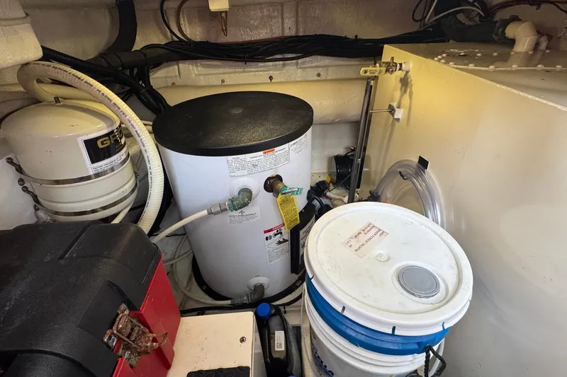 Slide: The Image of Engine room of 2007 Jefferson Pilothouse 52 SE with equipment and storage containers. - 33
