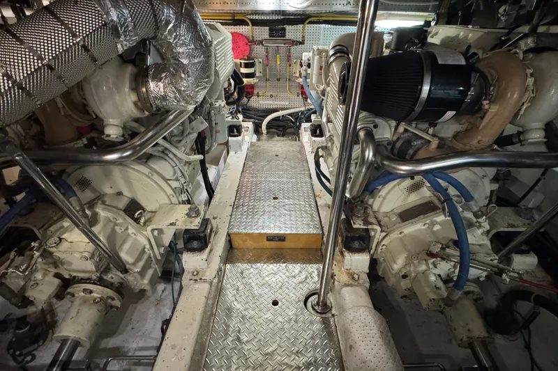 Slide: The Image of Engine room of a 2007 Jefferson Pilothouse 52 SE yacht, showcasing dual engines and metallic flooring. - 35