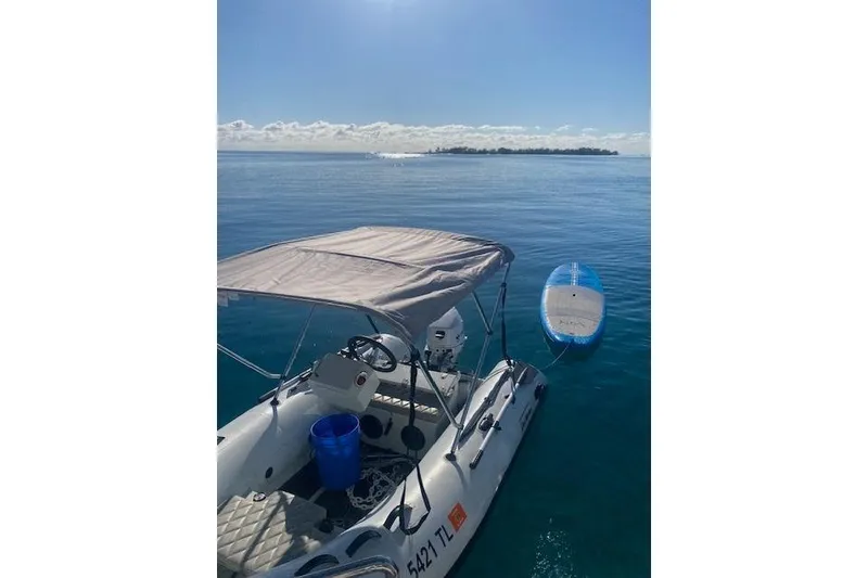 Slide: The Image of Inflatable boat with canopy on calm ocean, distant island view. - 41