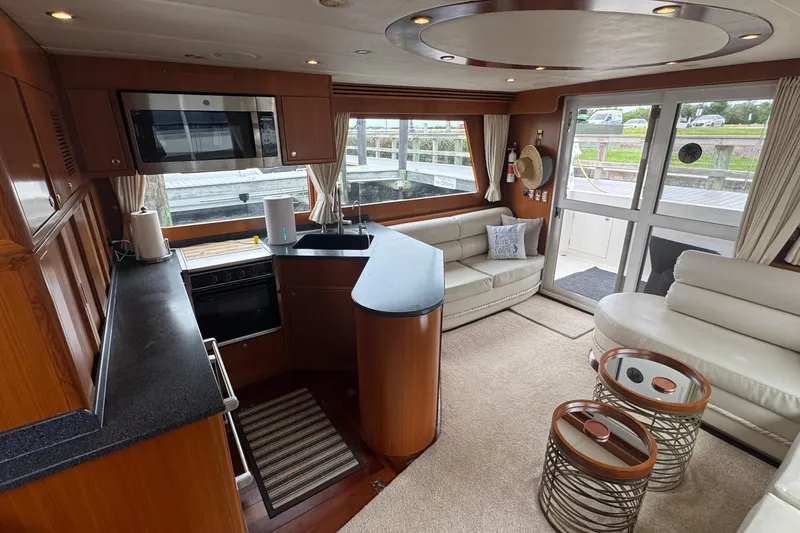 Slide: The Image of Luxurious interior of 2007 Jefferson Pilothouse 52 SE yacht with modern kitchen and seating area. - 6