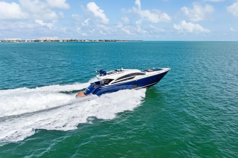 Slide: The Image of 2013 Pershing 82 yacht cruising on open blue sea under clear skies. - 12