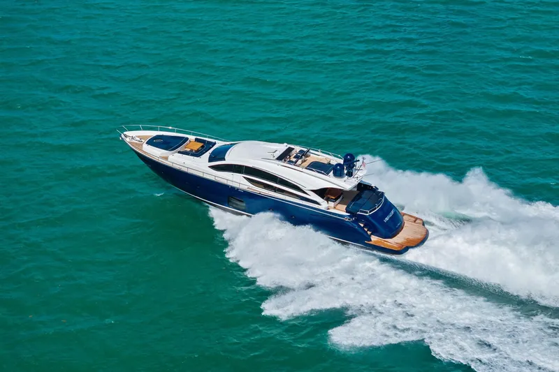 Slide: The Image of Luxury 2013 Pershing 82 yacht cruising on turquoise waters, showcasing sleek design and speed. - 15