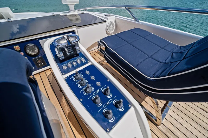 Slide: The Image of Control panel and seating on a 2013 Pershing 82 yacht, featuring sleek design and ocean view. - 23