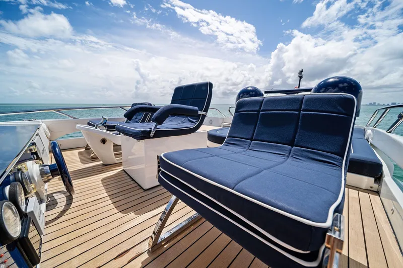Slide: The Image of Luxurious seating on 2013 Pershing 82 yacht deck, overlooking ocean under blue sky. - 24
