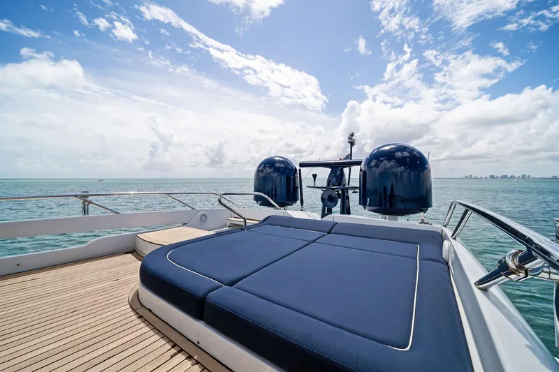 Slide: The Image of Luxurious 2013 Pershing 82 yacht deck with sunbed, overlooking serene ocean and blue sky. - 25