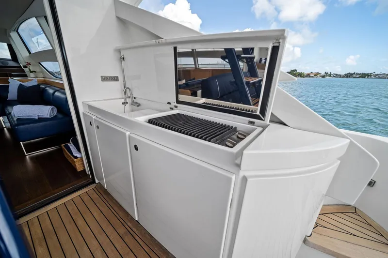 Slide: The Image of Outdoor kitchenette on 2013 Pershing 82 yacht with sink and grill, overlooking ocean. - 27