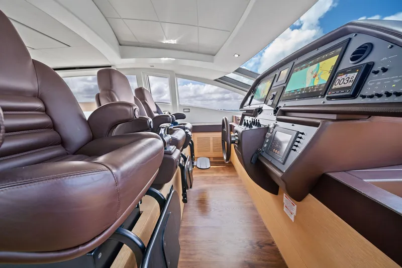 Slide: The Image of Luxurious interior of 2013 Pershing 82 yacht with leather seating and advanced navigation controls. - 33