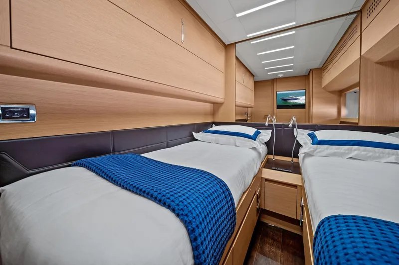 Slide: The Image of Luxurious twin cabin interior of 2013 Pershing 82 yacht with modern wood finish. - 39