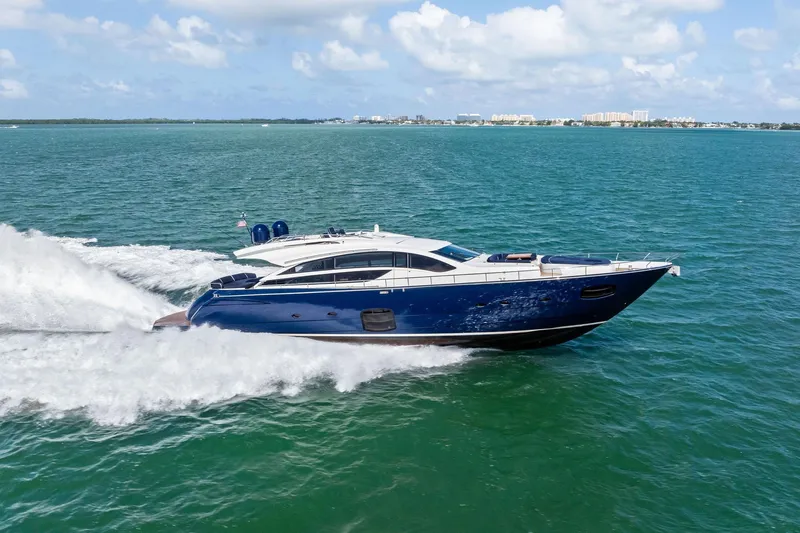 Slide: The Image of Luxurious 2013 Pershing 82 yacht cruising on open water under a clear blue sky. - 4