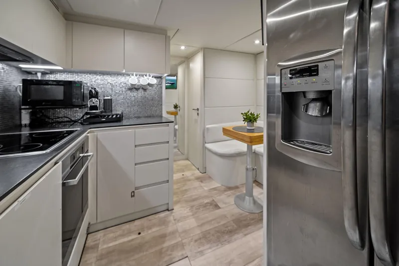 Slide: The Image of Modern kitchen interior on a 2013 Pershing 82 yacht, featuring sleek appliances and stylish decor. - 42