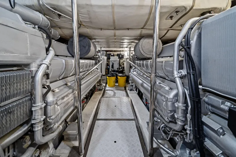 Slide: The Image of Engine room of a 2013 Pershing 82 yacht, showcasing dual engines and mechanical components. - 44