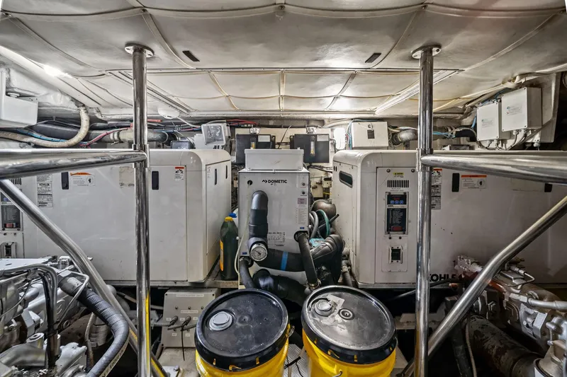 Slide: The Image of Engine room of a 2013 Pershing 82 yacht, featuring machinery and equipment. - 45