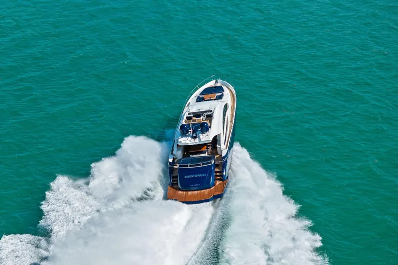 Slide: The Image of Luxury 2013 Pershing 82 yacht cruising on turquoise waters, leaving a foamy wake. - 5