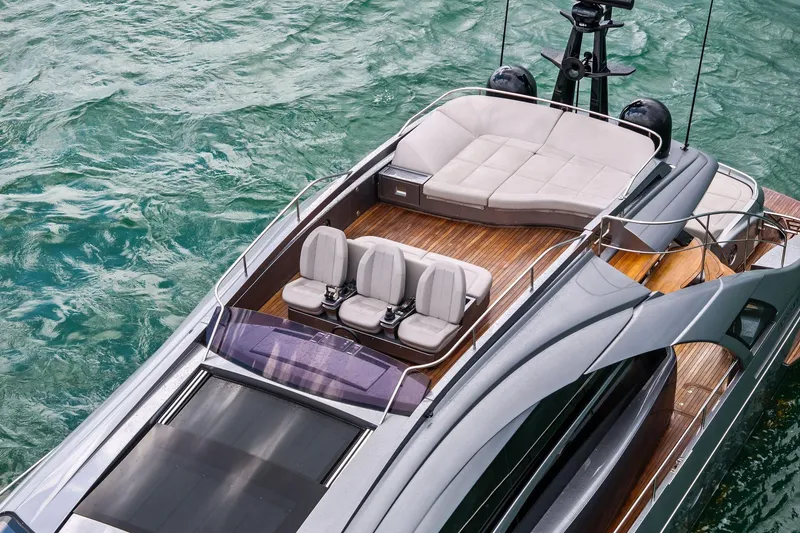 Slide: The Image of Luxurious 2021 Pershing 8X yacht with sleek design and elegant seating on turquoise water. - 12