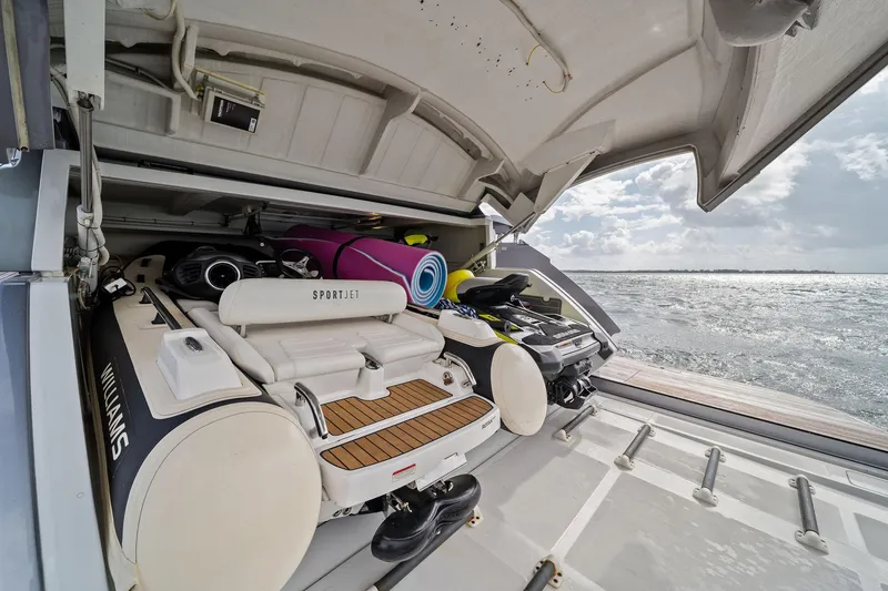Slide: The Image of Storage compartment of 2021 Pershing 8X yacht with watercraft and equipment. - 16