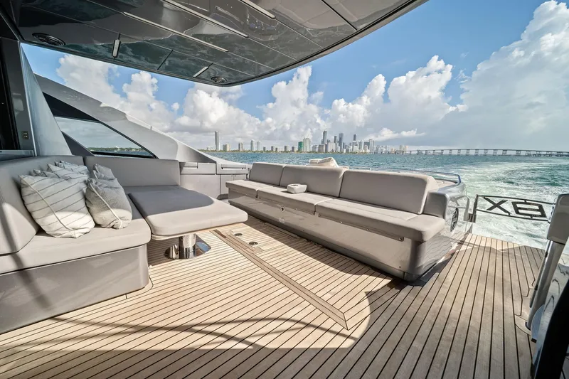 Slide: The Image of Luxurious 2021 Pershing 8X yacht deck with elegant seating and ocean view. - 21