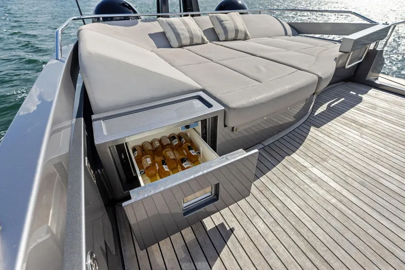 Slide: The Image of Luxurious 2021 Pershing 8X yacht with sunbed and built-in beverage cooler on deck. - 26