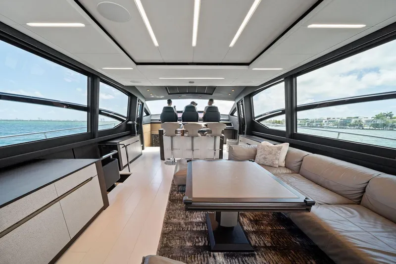 Slide: The Image of Luxurious interior of 2021 Pershing 8X yacht with modern seating and panoramic windows. - 27