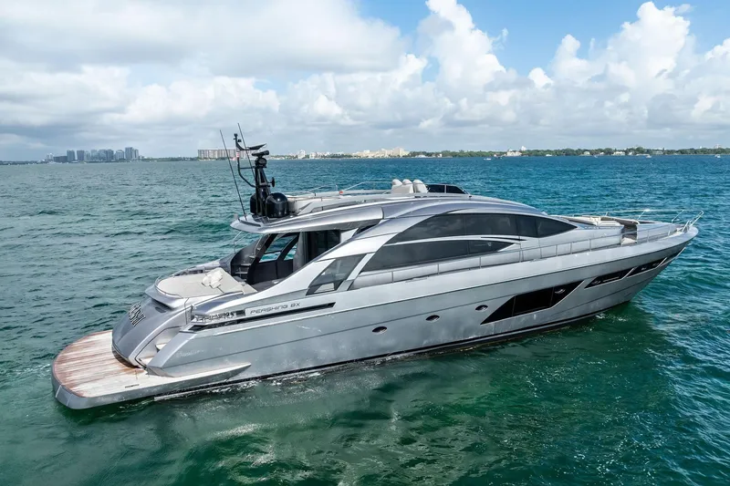 Slide: The Image of Luxury 2021 Pershing 8X yacht cruising on clear blue waters under a partly cloudy sky. - 3