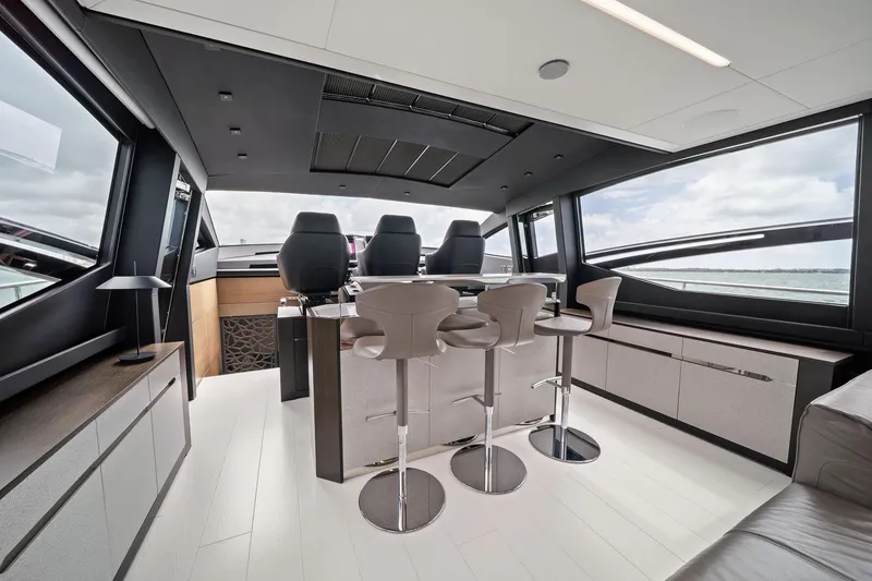 Slide: The Image of Luxurious interior of 2021 Pershing 8X yacht with modern seating and panoramic windows. - 30