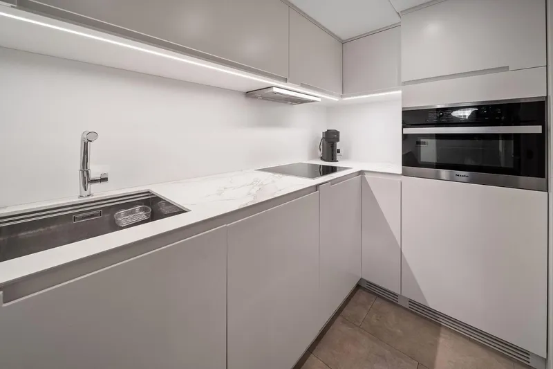 Slide: The Image of Modern kitchen in 2021 Pershing 8X yacht with sleek cabinetry and built-in appliances. - 34