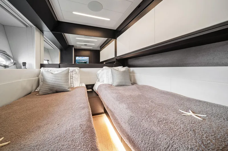 Slide: The Image of Luxurious twin cabin interior of 2021 Pershing 8X yacht with plush bedding and modern design. - 37