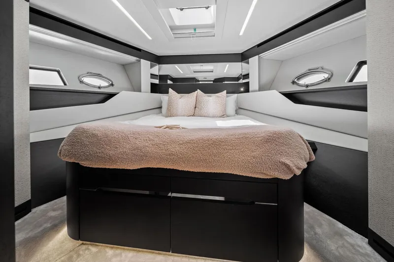 Slide: The Image of Luxurious bedroom interior of 2021 Pershing 8X yacht with modern design and plush bedding. - 38