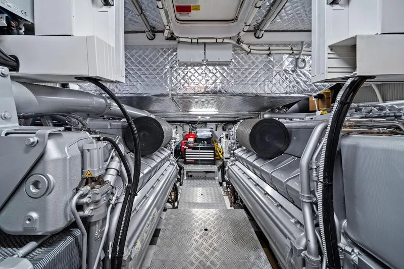Slide: The Image of Engine room of a 2021 Pershing 8X yacht, showcasing advanced machinery and equipment. - 43