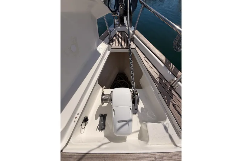 Slide: The Image of Anchor chain and windlass on 2005 Beneteau Oceanis Clipper 423 sailboat deck. - 23