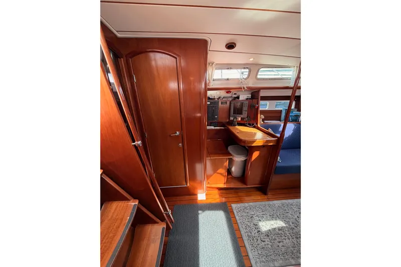 Slide: The Image of Interior of 2005 Beneteau Oceanis Clipper 423 sailboat with wooden finishes and navigation station. - 45