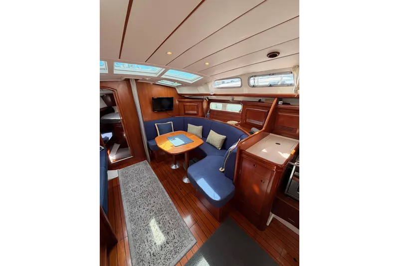 Slide: The Image of Luxurious interior of 2005 Beneteau Oceanis Clipper 423 yacht with blue seating and wooden finishes. - 52