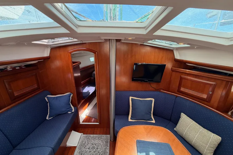 Slide: The Image of Interior of 2005 Beneteau Oceanis Clipper 423 sailboat with cozy seating and wooden finishes. - 57