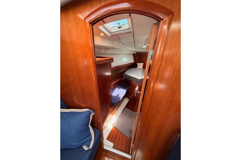 Slide: The Image of Interior of 2005 Beneteau Oceanis Clipper 423 yacht cabin with wooden finish and cozy bedding. - 58