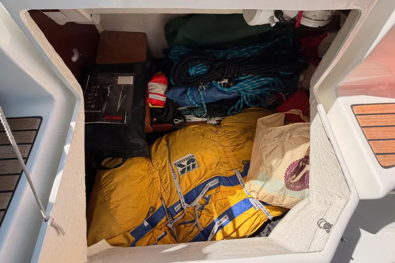 Slide: The Image of Storage compartment of a 2005 Beneteau Oceanis Clipper 423 with sailing gear and ropes. - 77