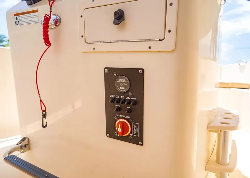 Slide: The Image of Scout 195 Sportfish 2022 console with switches and emergency cord. - 14