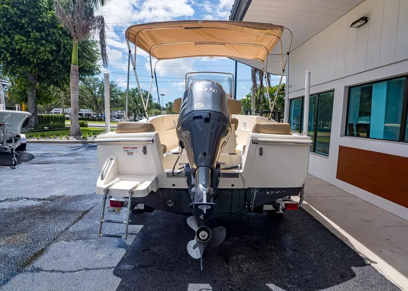 Slide: The Image of 2022 Scout 195 Sportfish boat with outboard motor and sun canopy. - 4