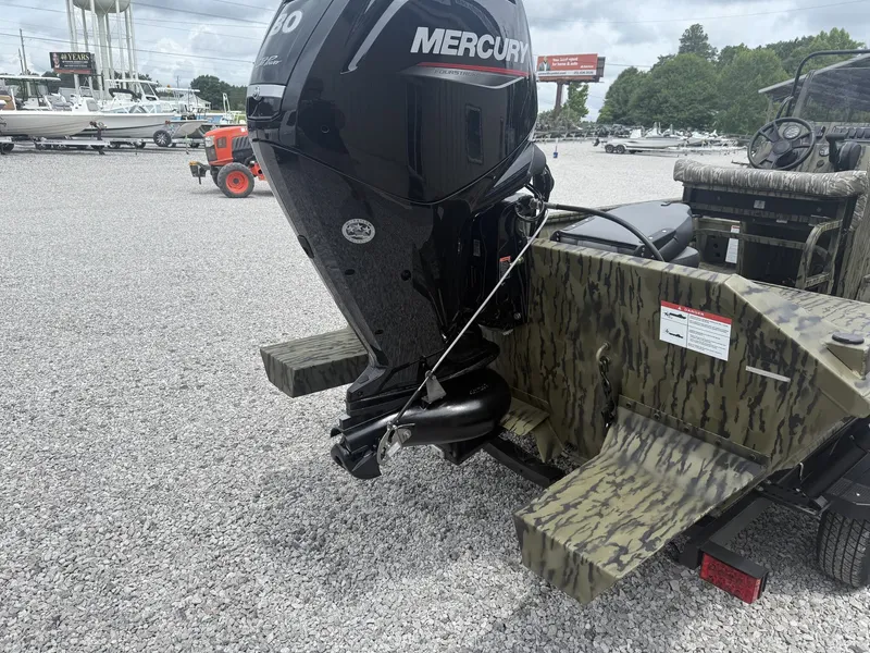 Slide: The Image of Lowe Roughneck 1760 Pathfinder 2026 with Mercury engine on gravel lot. - 4