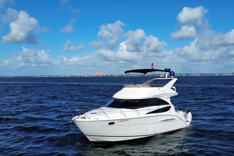The Image of 2006 Meridian 341 Sedan yacht cruising on open water under a clear blue sky. - 1
