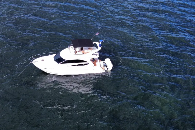 Slide: The Image of 2006 Meridian 341 Sedan yacht cruising on open water, aerial view. - 10
