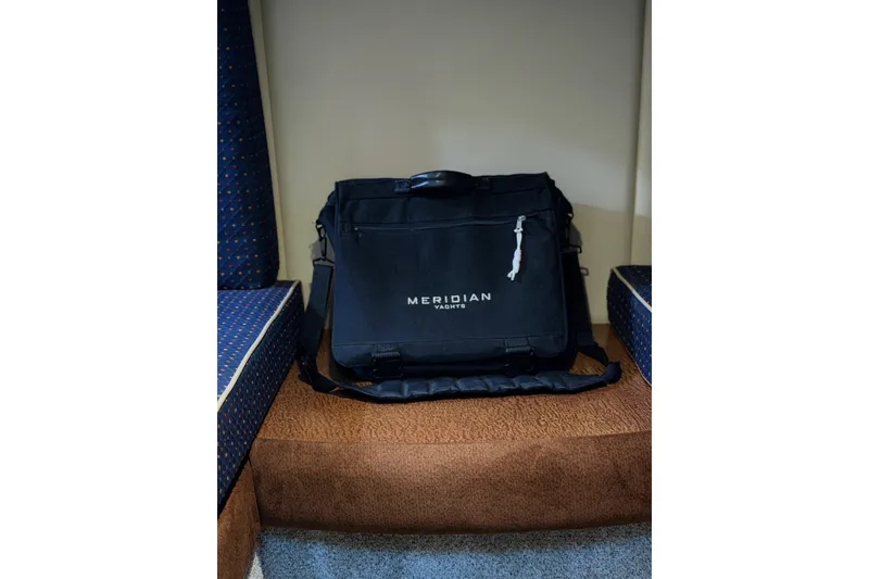 Slide: The Image of Black Meridian Yachts bag on a cushioned seat inside a 2006 Meridian 341 Sedan. - 24