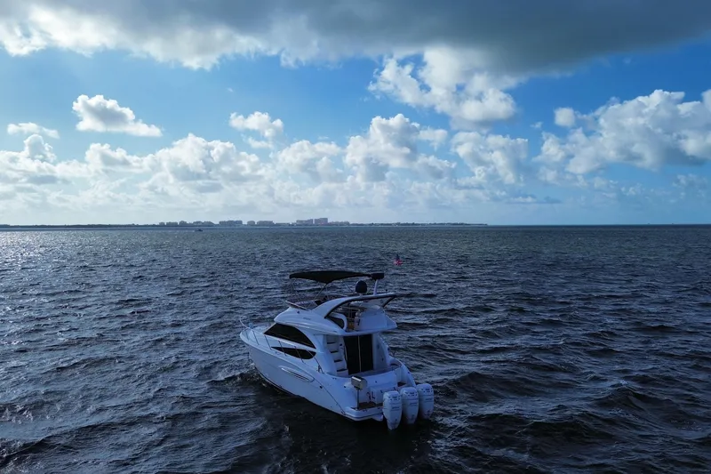 Slide: The Image of 2006 Meridian 341 Sedan yacht cruising on open sea under a partly cloudy sky. - 7