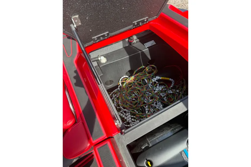 Slide: The Image of Open storage compartment in 2021 Malibu M220 boat with wiring and equipment. - 13