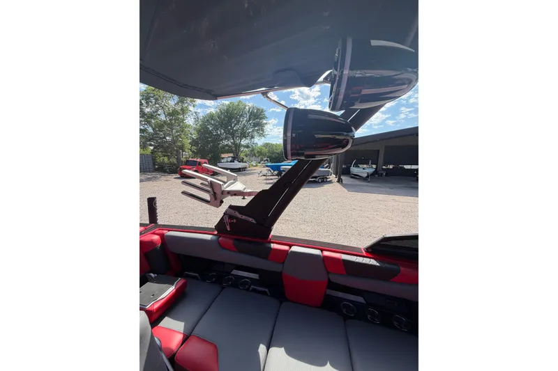 Slide: The Image of Interior view of 2021 Malibu M220 boat with red and gray seating. - 16