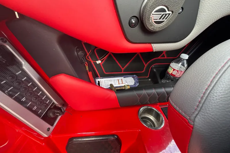 Slide: The Image of Interior of a 2021 Malibu M220 boat with red and black accents. - 25